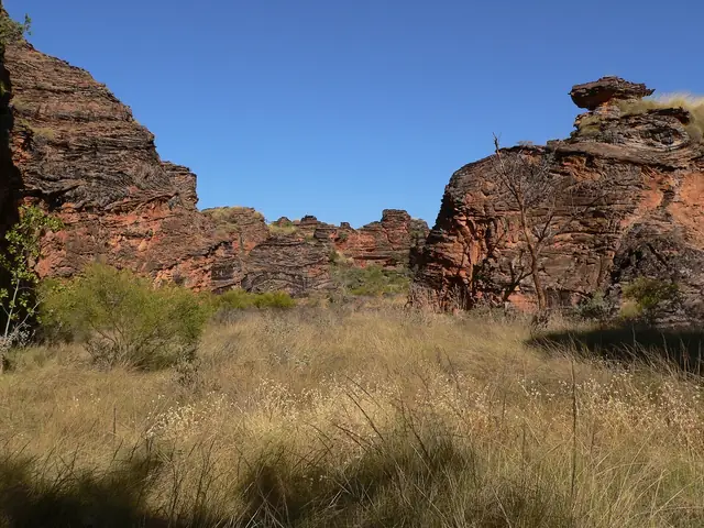A valley in Mirima National Park with dry grasses and rock walls